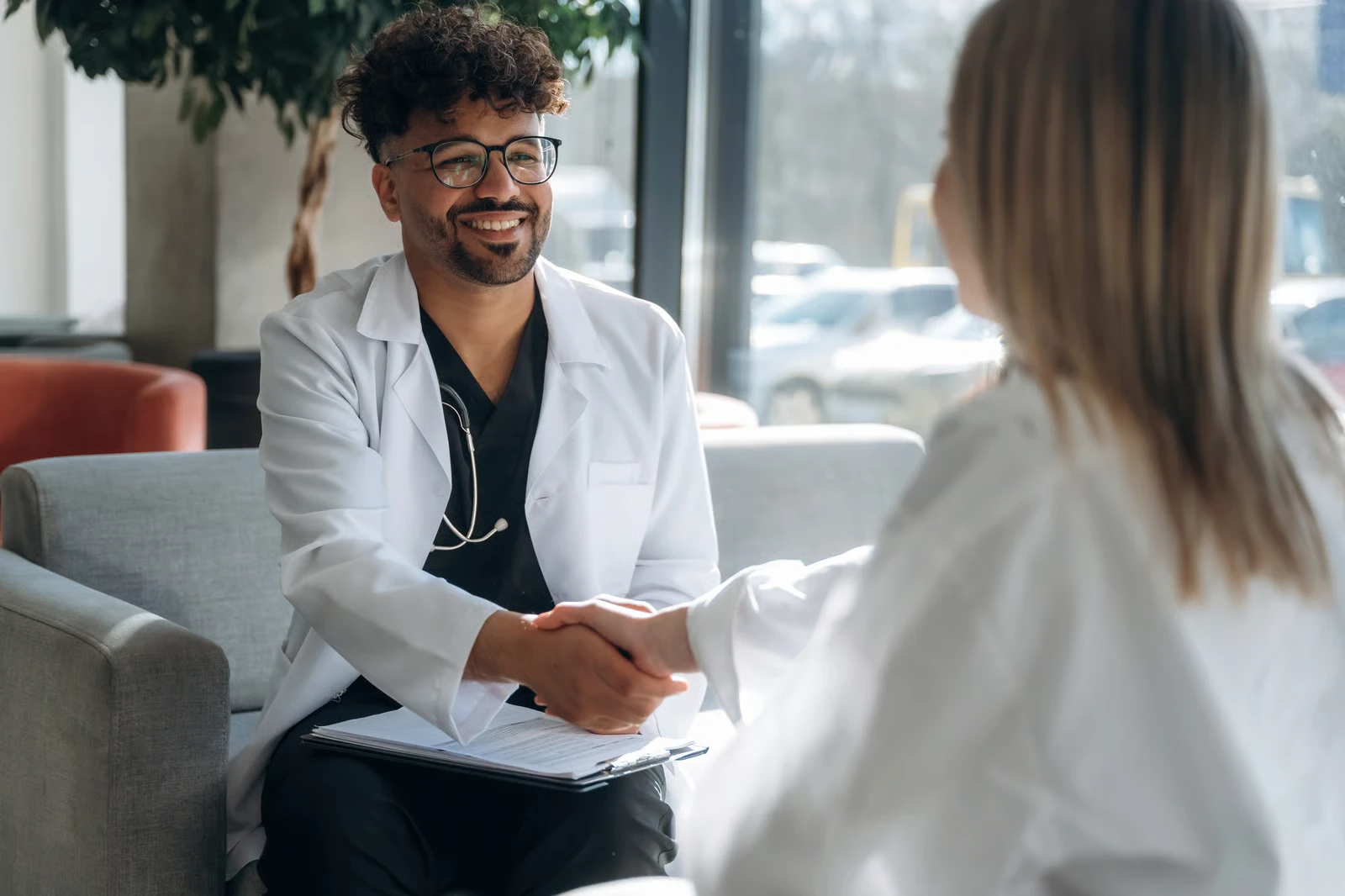 A GP and a colleague shaking hands